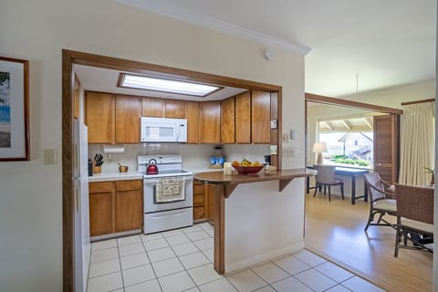 The passthrough in the kitchen keeps the flow open! You'll be able to keep the cook company from the comfort of the couch.