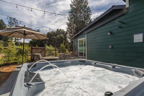 Unwind in the hot tub and soak up the peaceful backyard vibes.