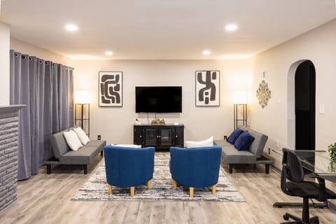 Enjoy the spacious room w/ a 55'' Smart TV, 2 desks and chairs for work or play!