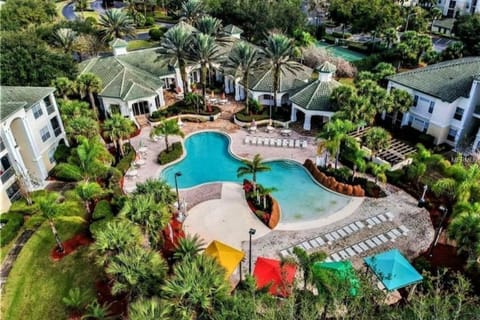 Main pool with walk-in entry and plenty of lounge chairs and shaded tables.  