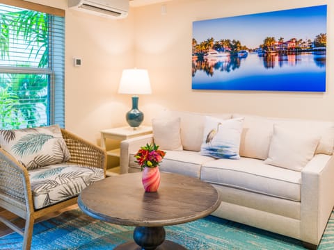 Room 504 - One bedroom suite | Living room | 65-inch flat-screen TV with digital channels