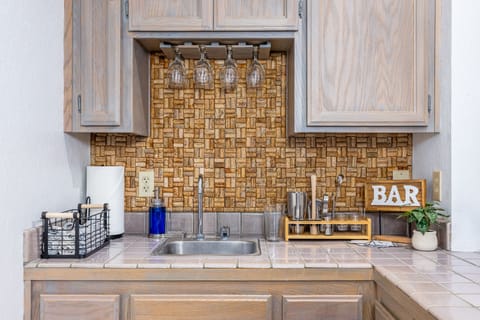 Fully stocked wet bar in game room.