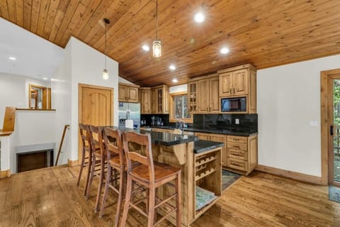 The bar/island that bridges the kitchen and living spaces makes for easy serving while also providing additional seating for four.