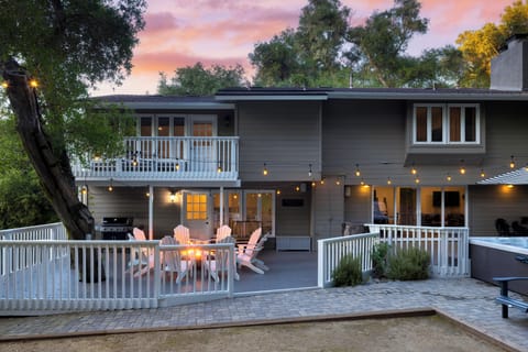 Inviting backyard patio with firepit, grill, and string lights.
