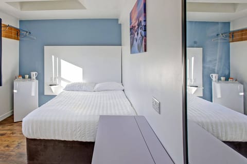 Desk, iron/ironing board, bed sheets