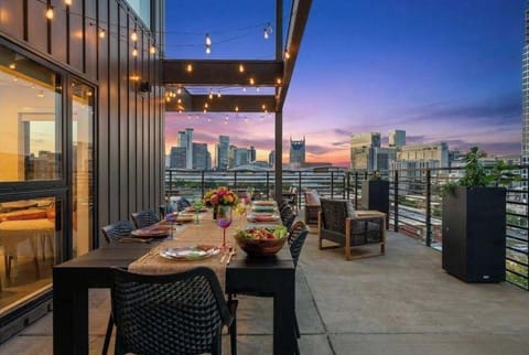 Spacious private balcony with city skyline view - dining table for 8 guests, perfect for family dinner, or a bachelorette events.