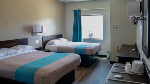 Desk, laptop workspace, bed sheets