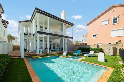 Spend your days relaxing by the private pool and hot tub overlooking the beach.