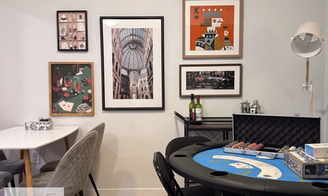Casino-style poker table setup with chips, cards, and bar cart
