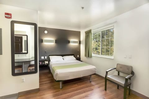 Desk, iron/ironing board, bed sheets, alarm clocks