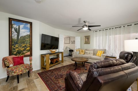 Lingroom has two leather recliners and large couch with Smart TV.