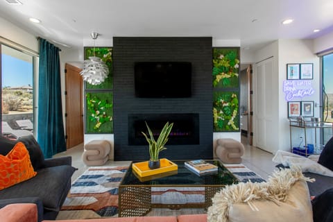 Living Room with Fireplace, TV and cocktail area.