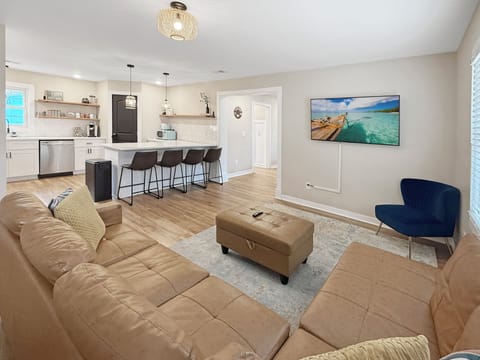 Bright open-plan living room and modern kitchen with island seating