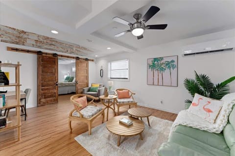 Modern living room with wooden sliding doors and tropical decor for a relaxing stay.