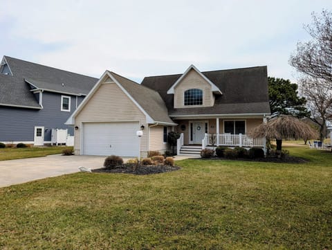109 Soft Shell Cove - Front Exterior and Driveway - A front view of the two-story home featuring a neutral siding color, a two-car garage, a concrete driveway, and a well-kept lawn.