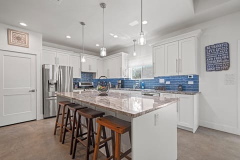 A kitchen for the chef at heart! This spacious kitchen has everything a cook could want: a large island, plenty of counter space, and stainless steel appliances.