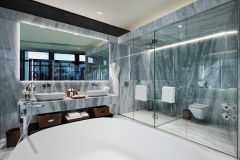 Ambassador Suite | Bathroom | Designer toiletries, hair dryer, bathrobes, slippers