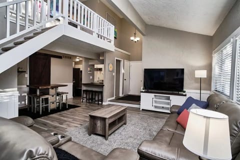 Living room with Smart TV and Leather couch with 4 reclining ends