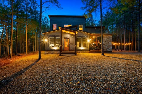 Your mountain escape glows against the pines before you even step inside.