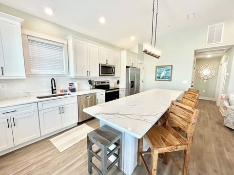 Bright kitchen with large island and seating for gathering.