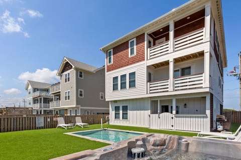 Back exterior with private pool and hot tub