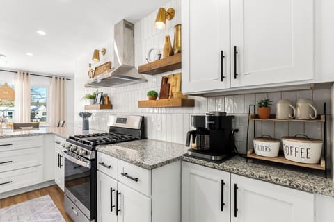 Transform your kitchen into a stylish haven with these white cabinets and a striking black stove. 🏡💫 Discover the joy of cooking in a space that reflects your impeccable taste!