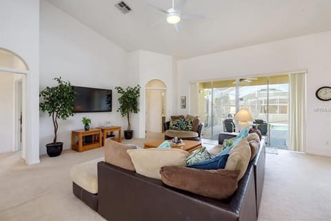 Spacious living area with cozy seating and abundant natural light for relaxing evenings.
