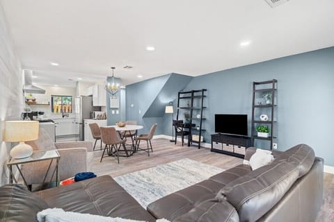 Living/Dining/Kitchen Area.  Sectional couch has been replaced with a sofa bed.