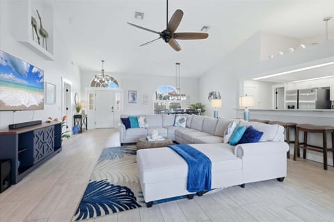 Bright, open living space. Living room features large, comfy sectional sofa and 75" Smart TV