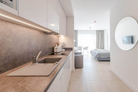 Another perspective of the kitchen, highlighting its sleek finishes and integration into the open-plan space.







