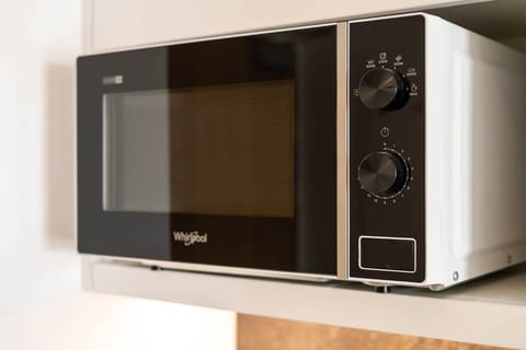 A close-up of a modern microwave neatly placed on a countertop, showcasing a functional and stylish appliance.
