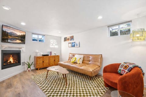 Relax in this inviting lounge space with a decorative fireplace, plush seating, and thoughtfully curated design.