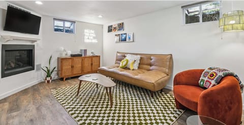 Relax in this inviting lounge space with a decorative fireplace, plush seating, and thoughtfully curated design.