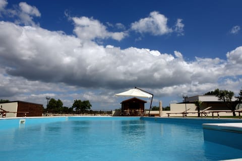 Seasonal outdoor pool, open 9 AM to 6 PM, pool umbrellas, sun loungers
