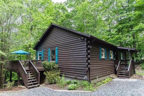 Charming forest cabin with colorful accents and a spacious outdoor decks.
