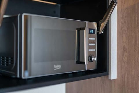 A close-up of a built-in microwave, neatly integrated into the kitchen, offering a modern and functional design.
