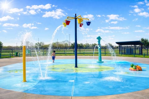 Splash pad in park behind house