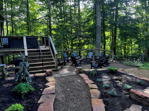 The peaceful outdoor setting at Pine Lane cannot be beat! Surrounded by woods Pine Lane offers a fire pit, lawn for playing, gas grill, hot tub, and covered porch/living area,