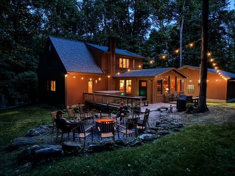 Unwind beneath the string lights in your own secluded backyard—complete with a hot tub, fire pit, and nothing but forest around you.