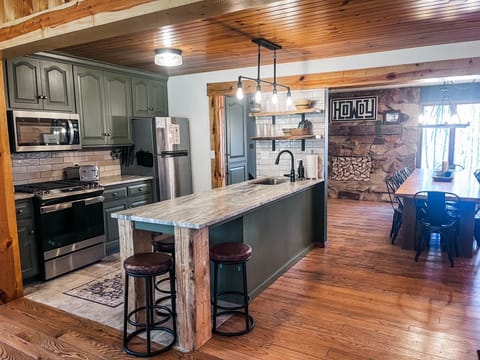 This freshly updated kitchen sits at the center of it all—open to a spacious dining room on one side and the cozy living room with a stone fireplace on the other. Whether you're cooking, gathering, or just snacking, there's room for everyone to be part of the moment.