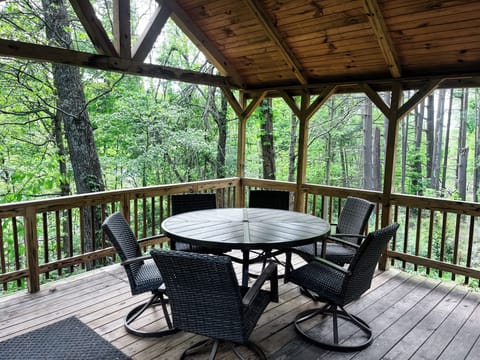 Tucked beneath the trees, this covered deck is perfect for a morning coffee, a laid-back meal, or a late-night round of cards.
Whatever the hour, it’s a peaceful spot to unwind in the fresh air.
