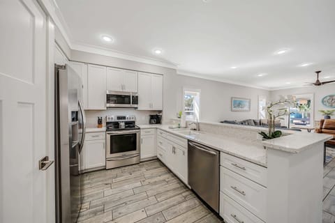 The fully equipped kitchen features beautiful recycled glass countertops and stainless-steel appliances.