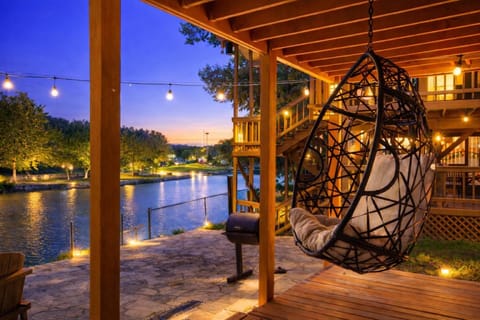 Wake up to serene Guadalupe River views from the comfort of the hanging porch swings.