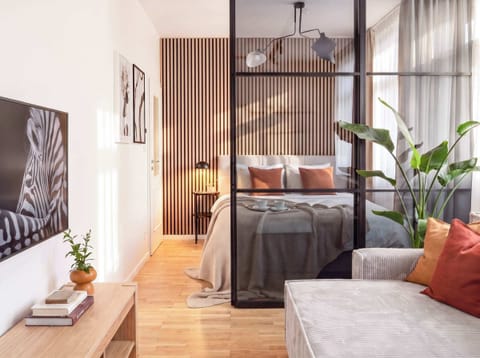 Second bedroom is separated from the living room with a glass wall and blinds for extra privacy.