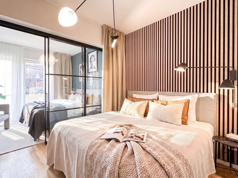 An innovative layout creates two separate bedrooms using elegant glass partitions and full-length privacy curtains, offering the perfect balance of openness and comfort.