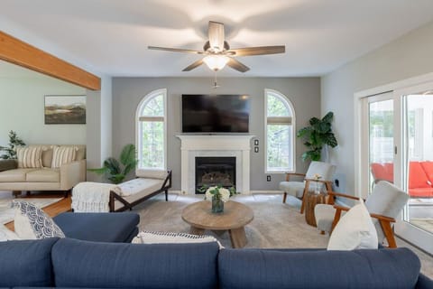 Spacious main lounge with smart TV, plush sofas, and natural light , perfect for gathering with family after a Cape May adventure