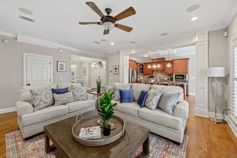 Experience the perfect blend of open concept living with this inviting space, where the living room seamlessly flows into a spacious kitchen nestled in the background.
