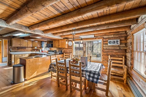 Dining room with log table and chairs.