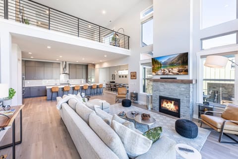 Stunning living room offers a warm gas fireplace and luxury seating for guests while they enjoy watching the large flat screen tv.