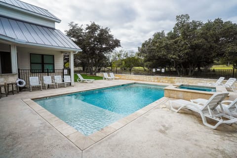 Sun shelf with steps in, built-in seating, and a waterfall hot tub all in one!